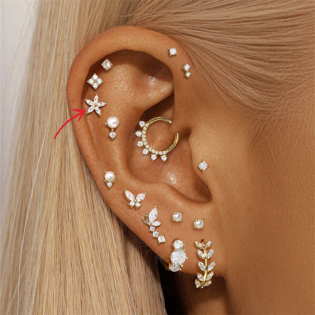 A dainty 14K gold flower-shaped earring, adorned with marquise-cut zirconia for a stunning finish.