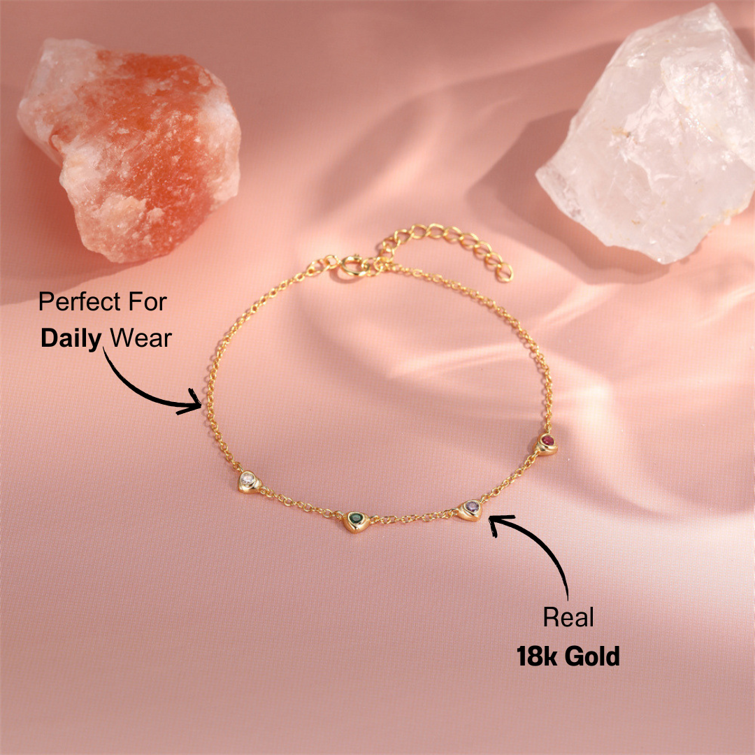 14k-gold-gemstone-bracelet-pink-background.png – Stunning 14k gold bracelet with vibrant gemstones, displayed on a soft pink background for an elegant, feminine touch.