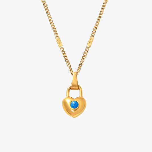 A gold heart-shaped padlock pendant necklace with a small turquoise stone in the center, displayed on a plain white background.