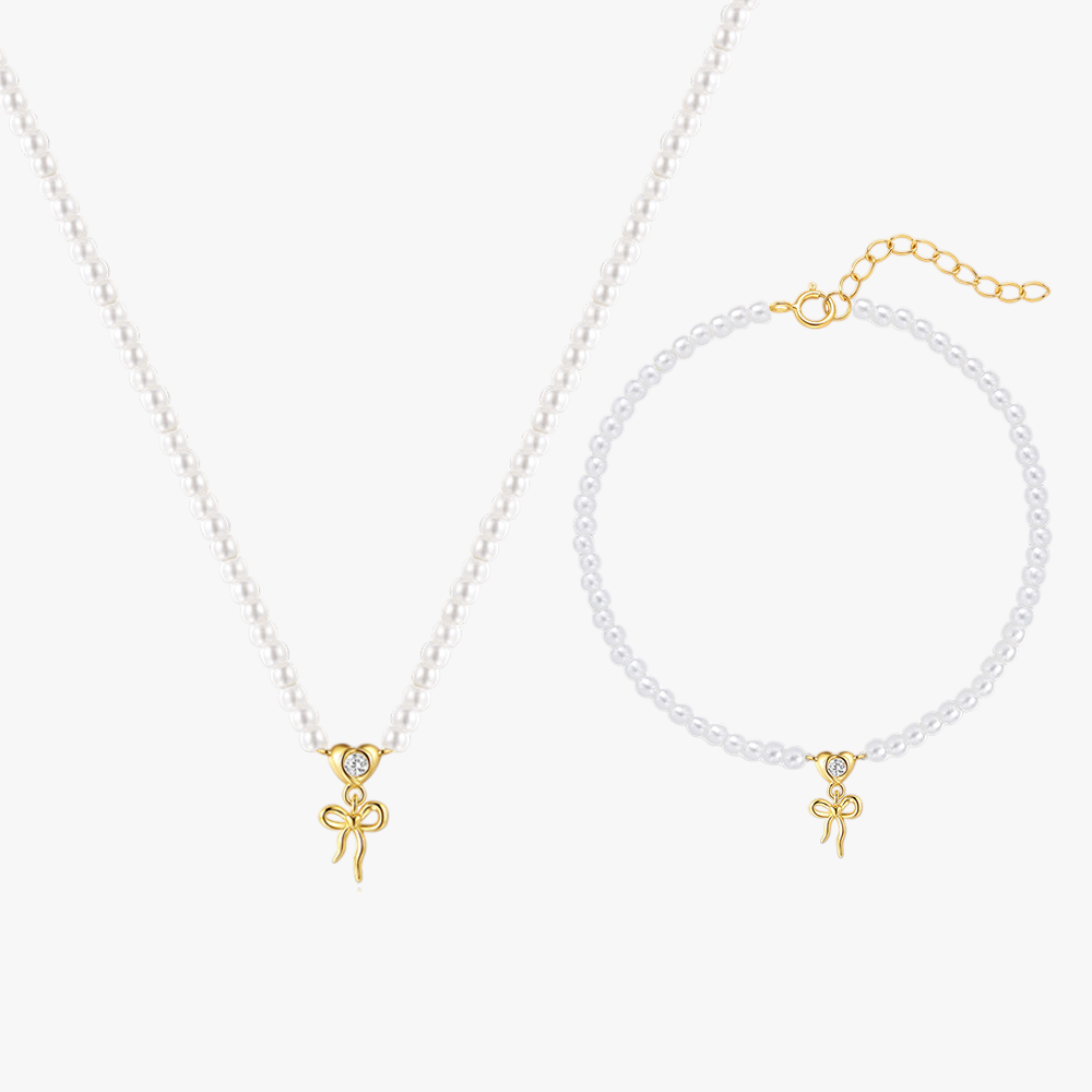 14k-gold-pearl-necklace-bracelet-bow-charm-main.png – Elegant pearl bracelet with a 14k gold bow charm, featuring adjustable chain closure for a classic and feminine touch.