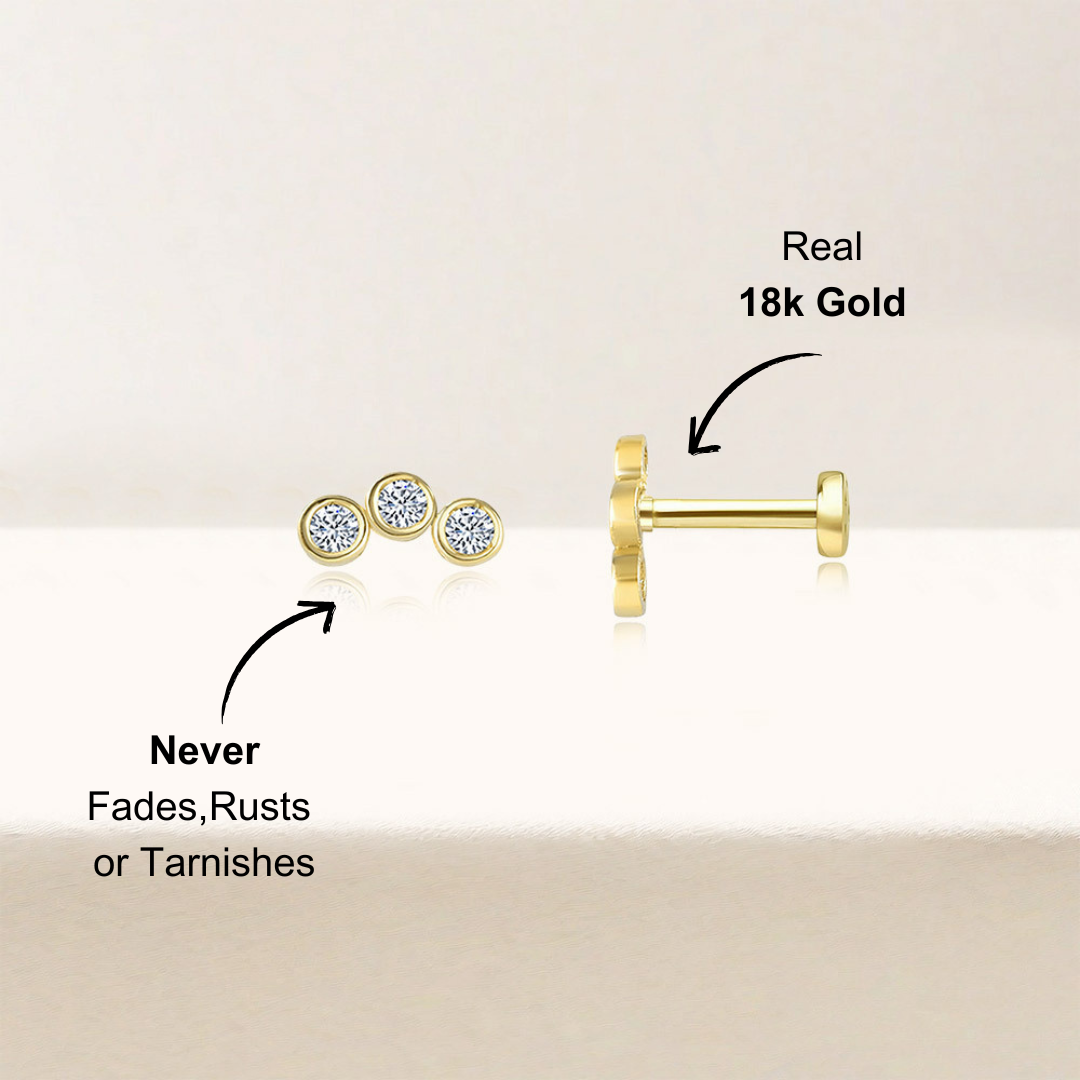 Side view of a 14k gold-plated 925 sterling silver stud earring with three zirconia stones, showcasing its smooth and polished design.