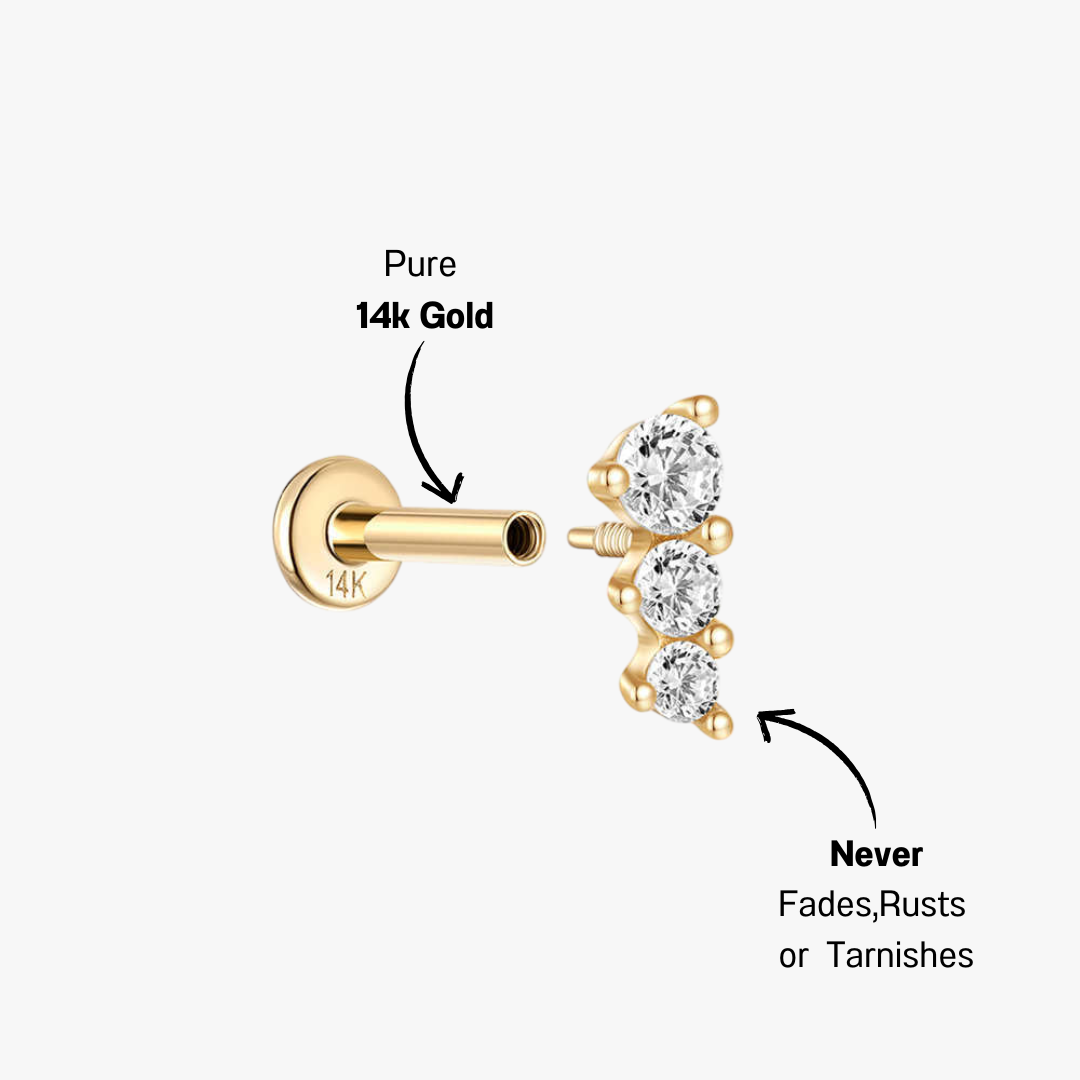 Delicate 14k gold earrings featuring three round-cut zirconia stones in a simple, modern design.