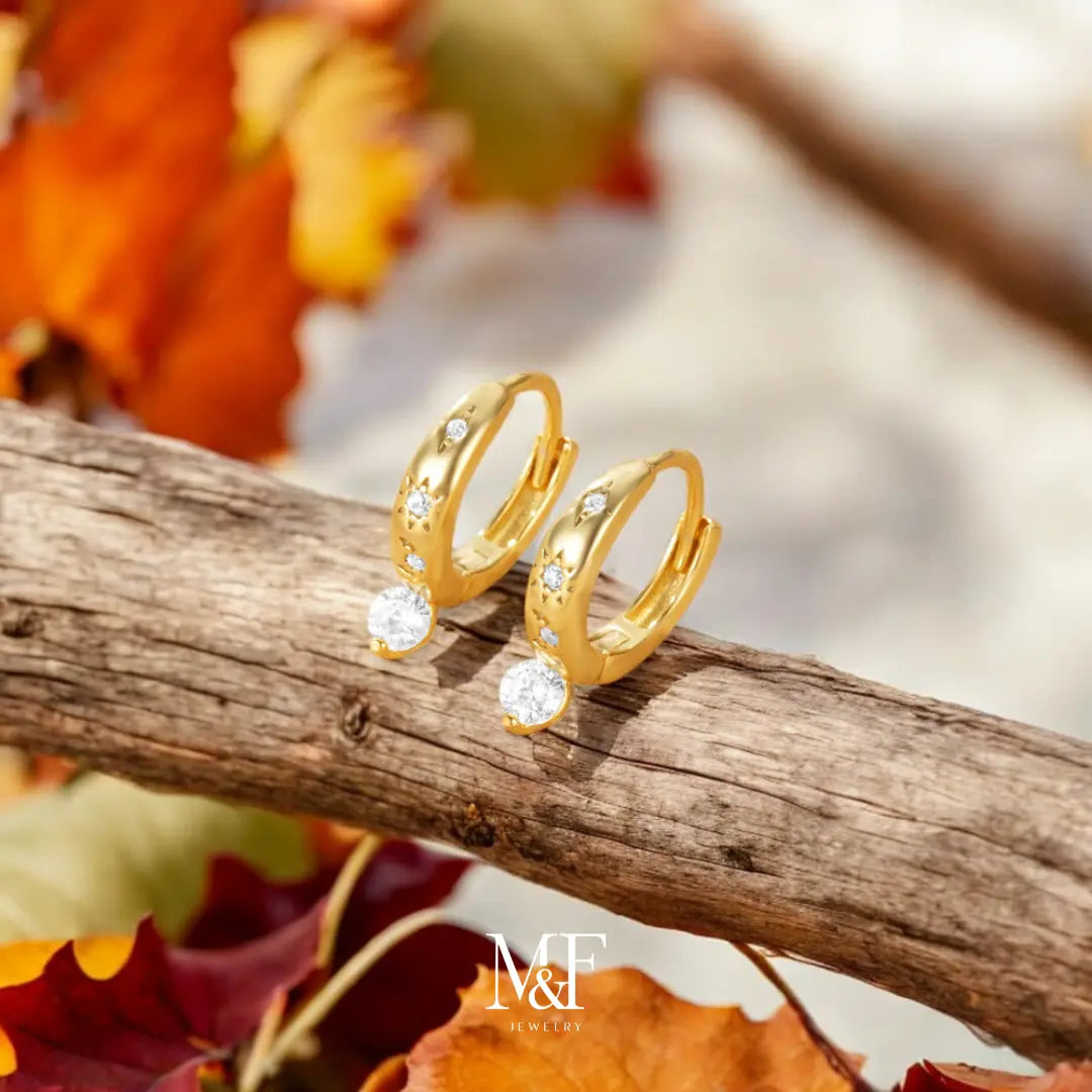 Gold Huggie Earrings with Crystal Drop – A sophisticated take on the classic huggie, these earrings add a touch of sparkle with a stunning crystal drop.