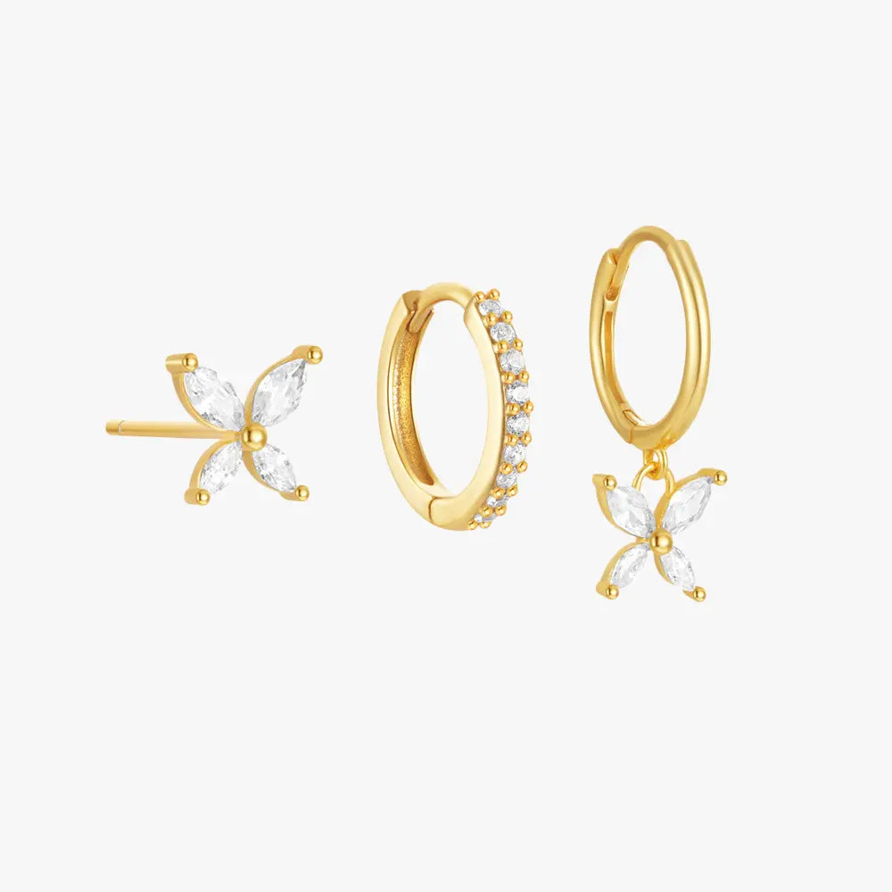 Gold butterfly stud and hoop earrings set with cubic zirconia stones. One hoop earring features a dangling butterfly charm.