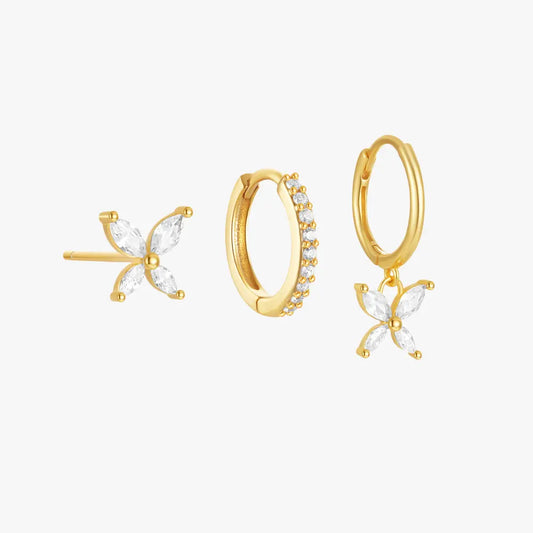 Gold butterfly stud and hoop earrings set with cubic zirconia stones. One hoop earring features a dangling butterfly charm.