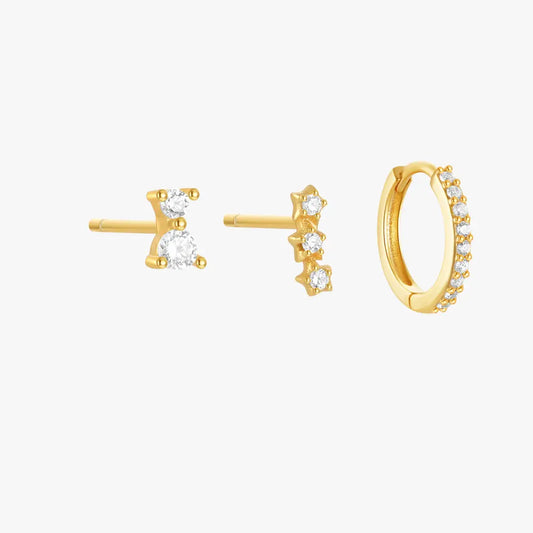 Set of three gold earrings with cubic zirconia accents: one minimalist stud, one star-studded row, and a pave hoop earring.