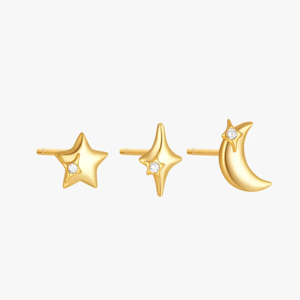 A set of three gold-plated stud earrings featuring a star, a sparkling starburst, and a crescent moon design with tiny gemstones.