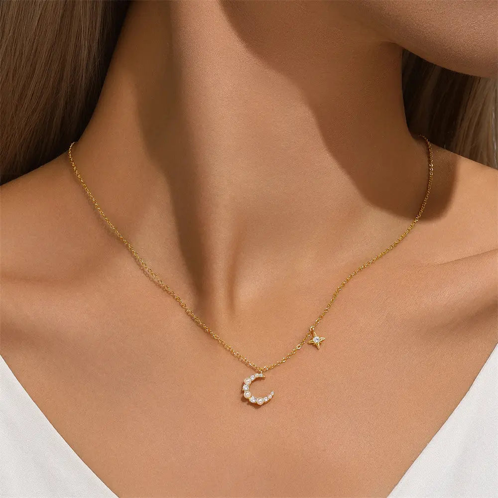 Model wearing a gold crescent moon and star necklace, showcasing its elegant and minimalist design around the neck.