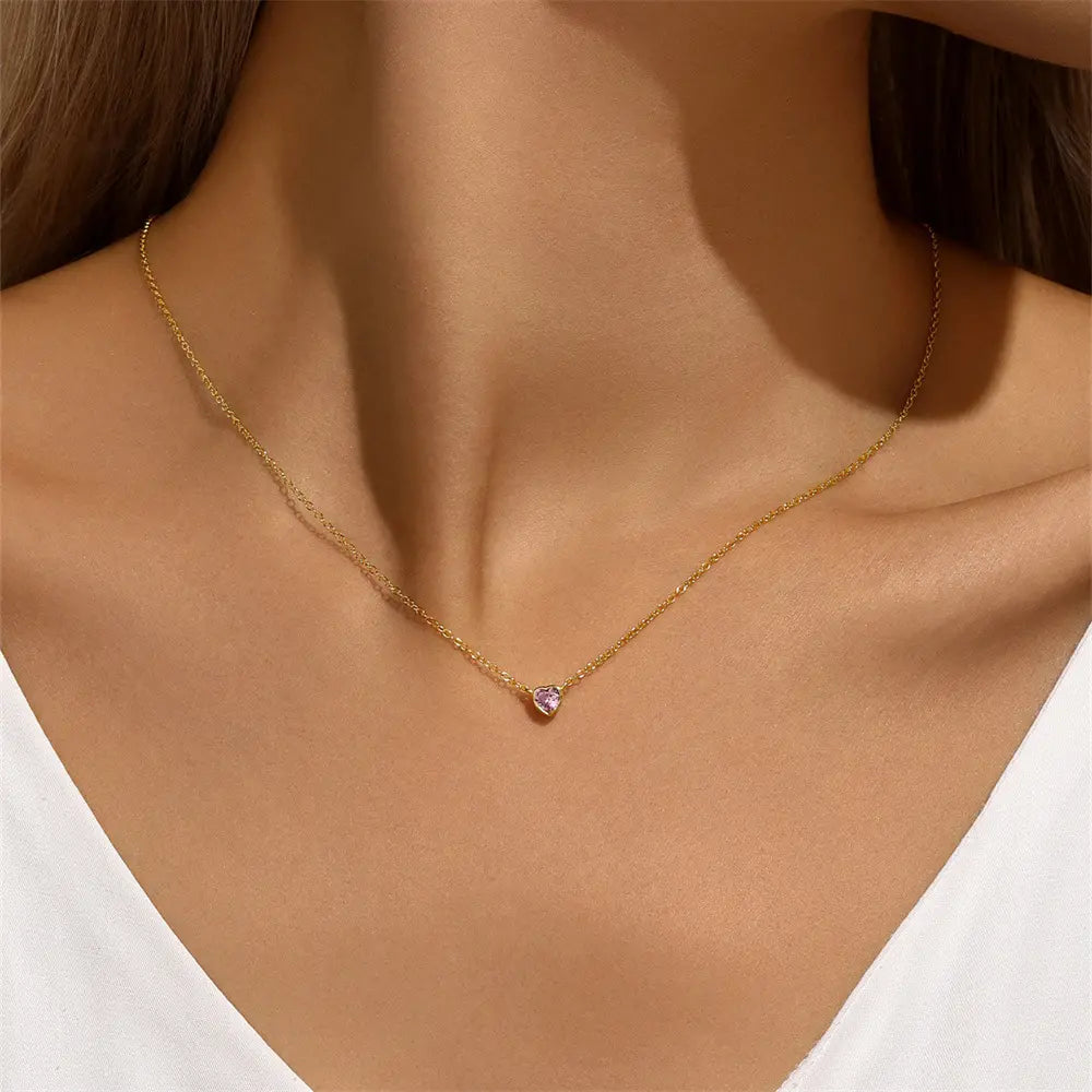 Woman wearing a delicate heart-shaped pink gemstone necklace, showcasing its lightweight and versatile design, perfect for everyday elegance.