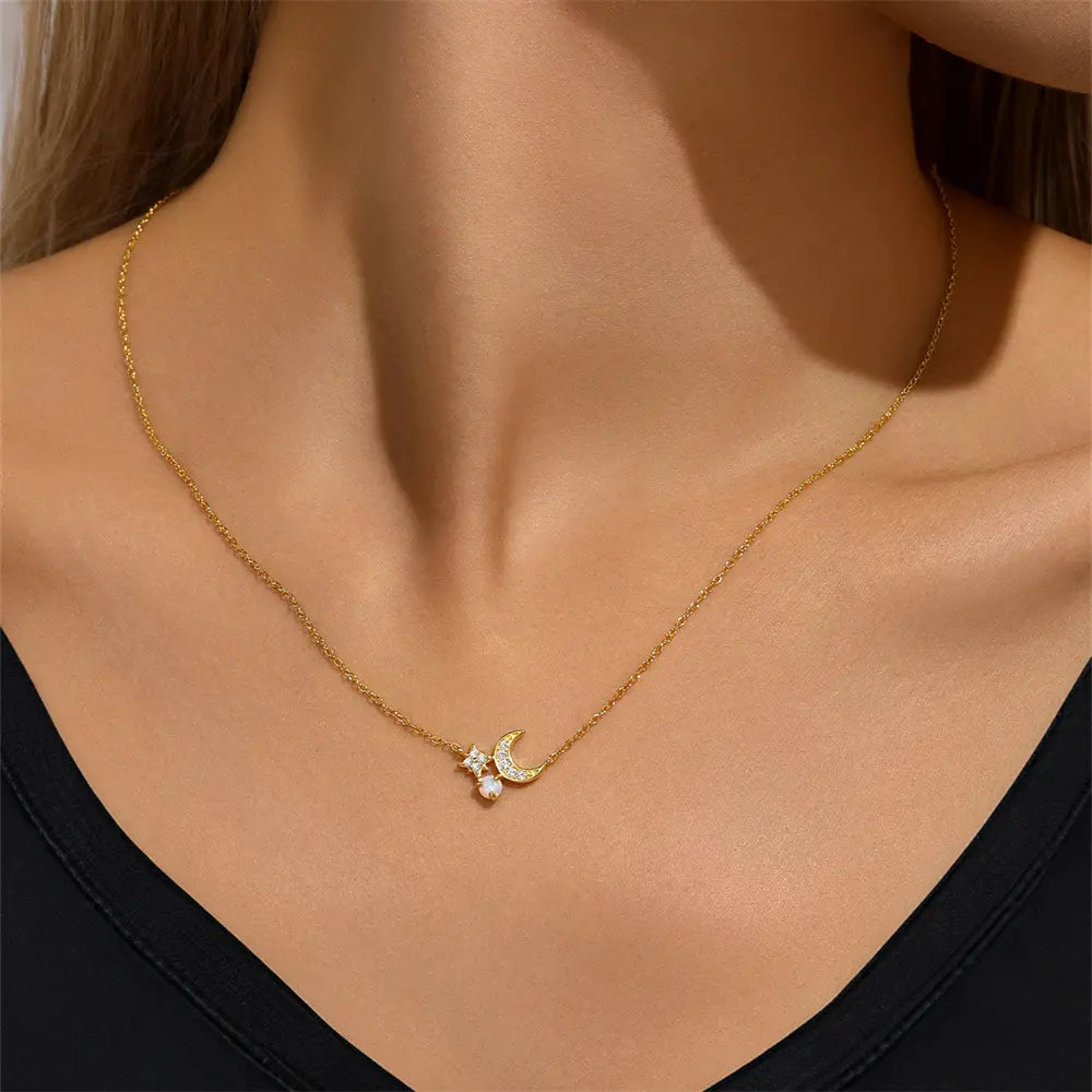 Model wearing a celestial-inspired necklace featuring a crescent moon, star, and a pearl charm.