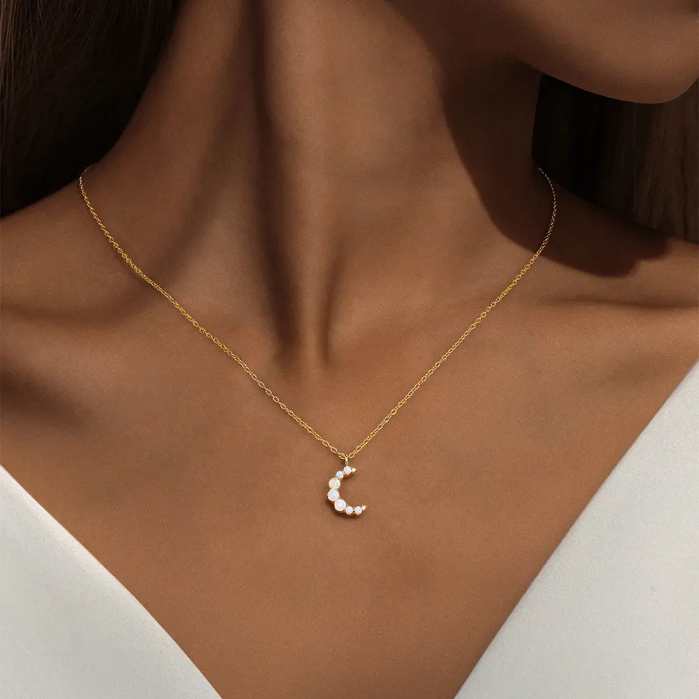 Model wearing 925 sterling silver opal moon necklace with zirconia stones