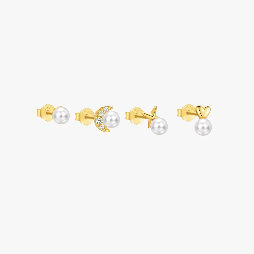 Set of four gold stud earrings with pearl accents, featuring moon, star, heart, and classic round designs, crafted in 925 sterling silver.