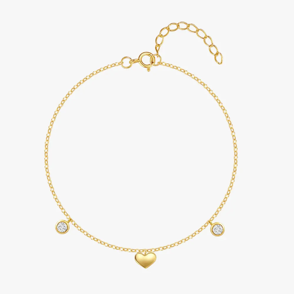 925 sterling silver heart bracelet with zirconia on gold chain, front view on white background.