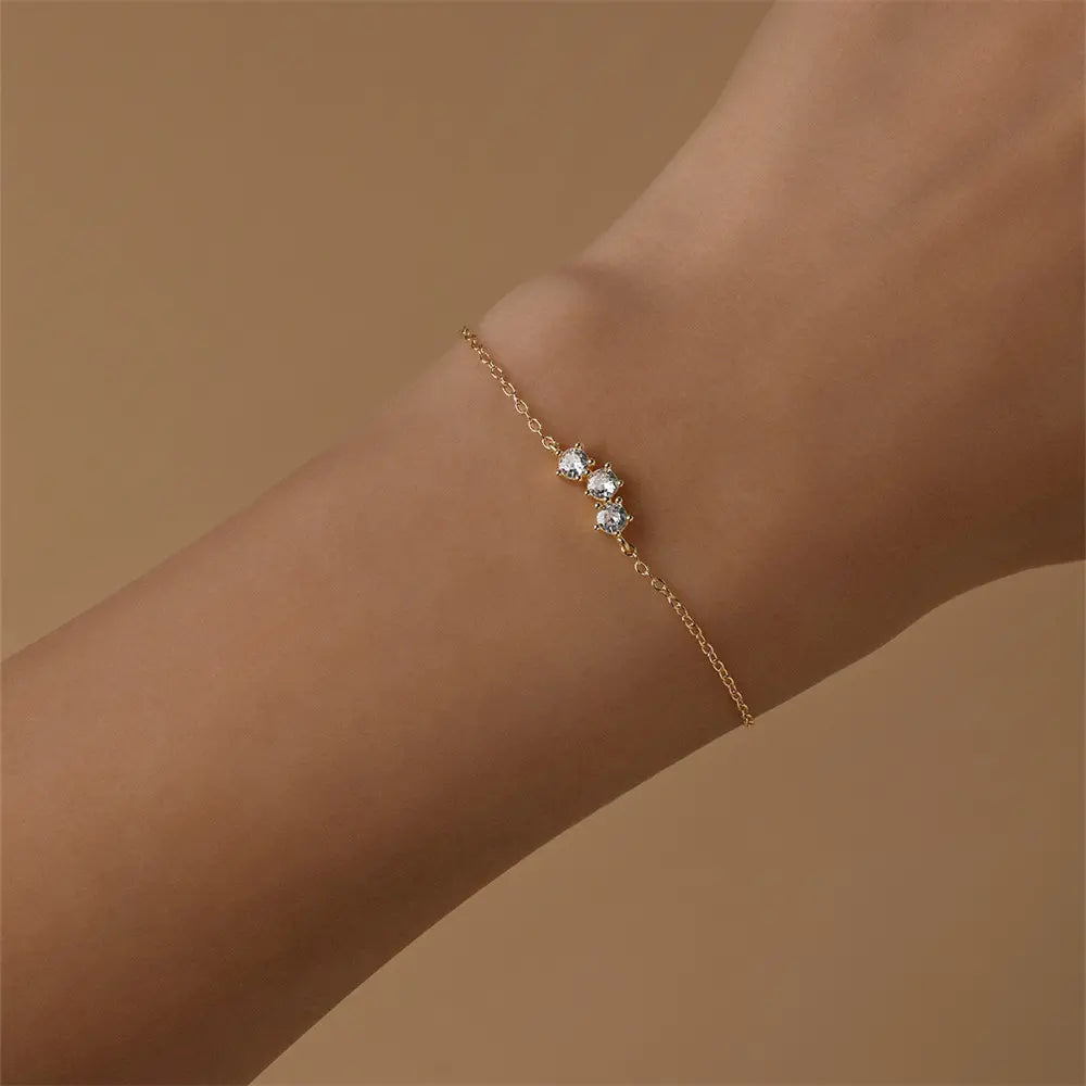 925 sterling silver bracelet with a row of zirconia stones, worn on a hand, showcasing an elegant minimalist design.