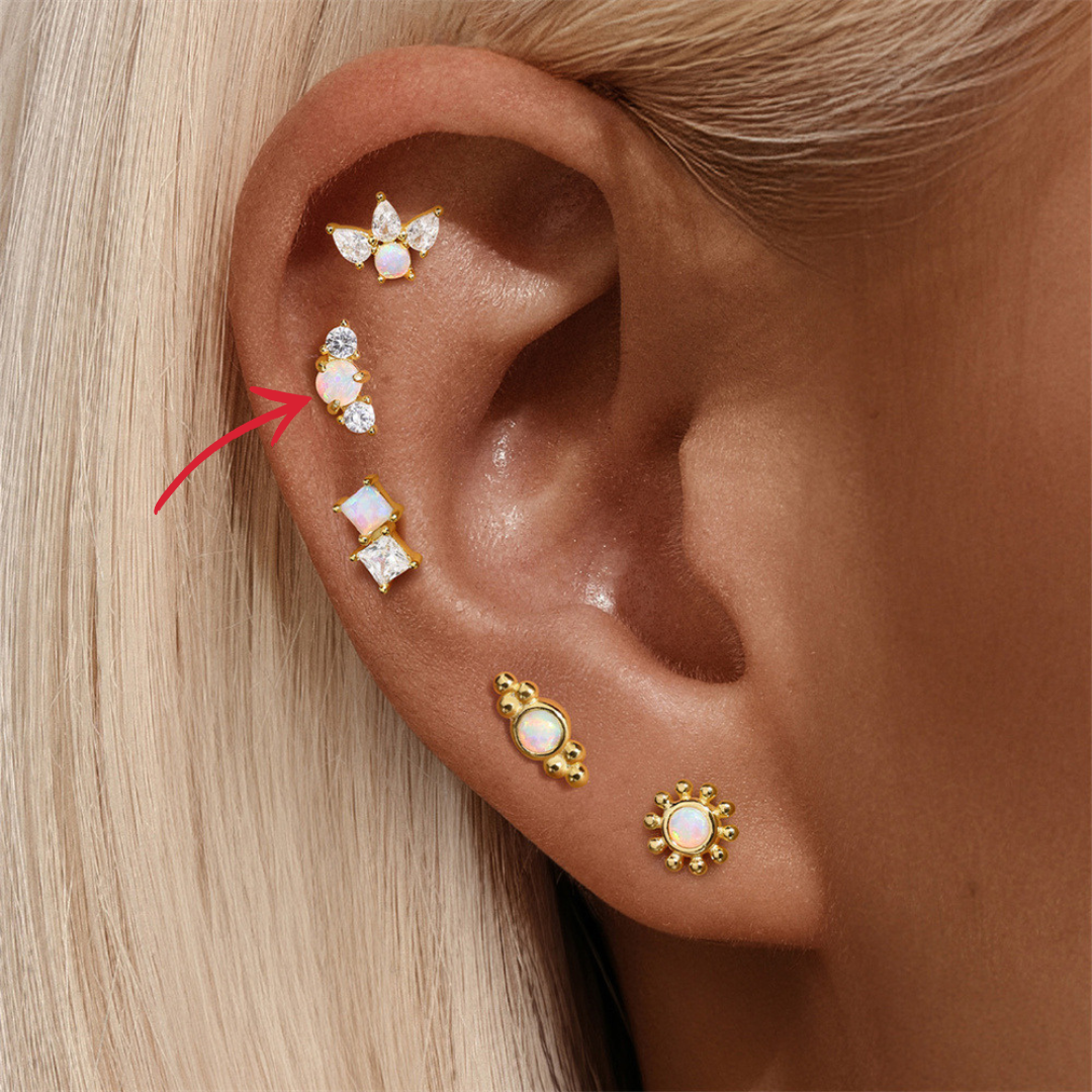 Model showcasing a beaded opal cartilage stud in the lower helix. A small yet statement-making earring in gold-plated sterling silver.