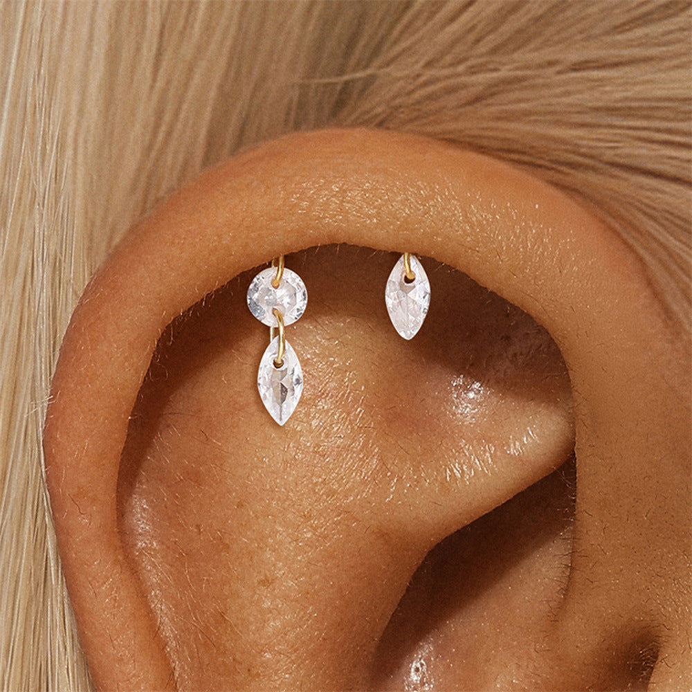 Close-up of a gold-plated 925 sterling silver cartilage earring with crystal dangles, elegantly worn on the ear.