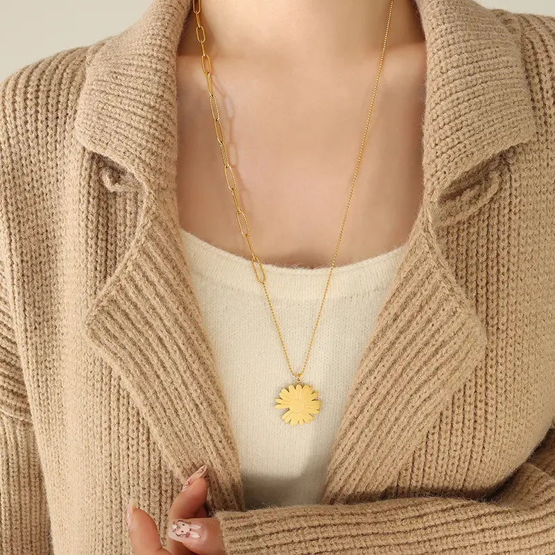 Elegant daisy pendant sweater chain necklace worn by model with beige cardigan, showcasing minimalist charm and modern design.