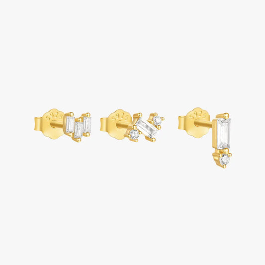 Set of three gold stud earrings featuring baguette and round-cut crystals, crafted in 925 sterling silver, showcasing a minimalist and modern jewelry design.