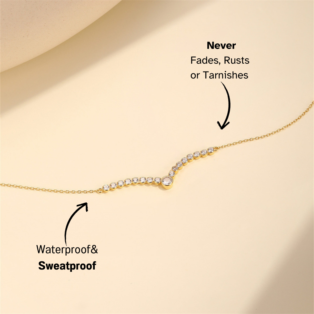 Dainty gold necklace with bezel-set cubic zirconia stones, designed for layering or solo wear.