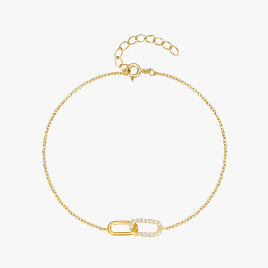 Elegant gold crossover zirconia Bracelet with sparkling details, displayed on a white background.