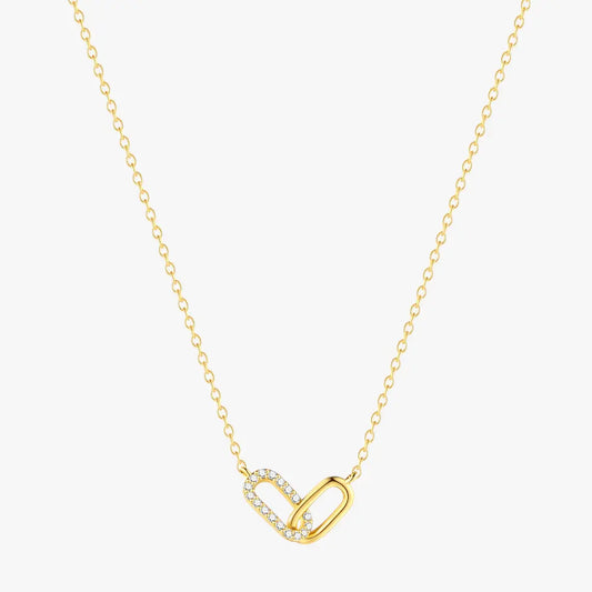 Elegant gold crossover zirconia necklace with sparkling details, displayed on a white background.