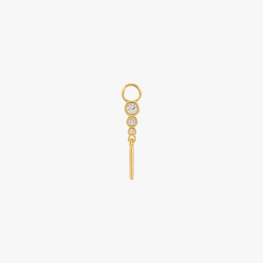 A gold charm with a diamond bar.