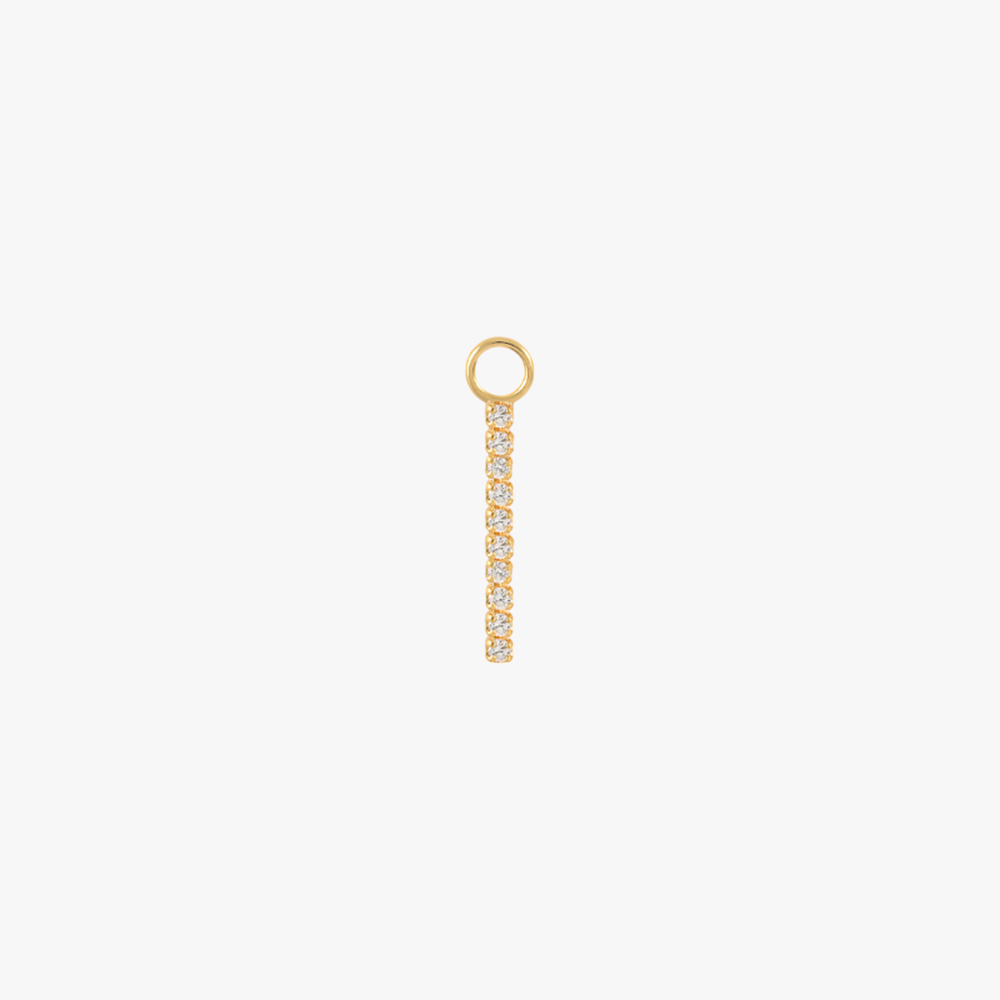 A gold charm with a diamond bar.