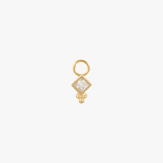 A gold charm with a diamond.