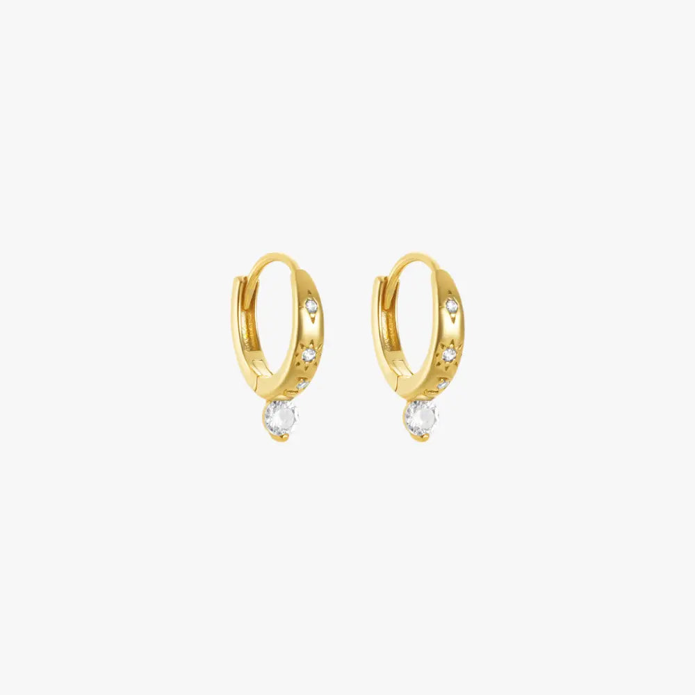 A pair of gold hoop earrings with diamonds.