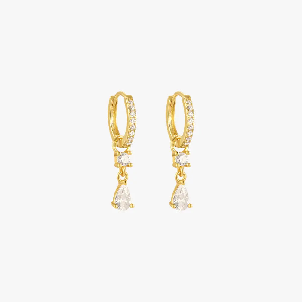 A pair of gold hoop earrings with teardrop charms, set with diamonds.