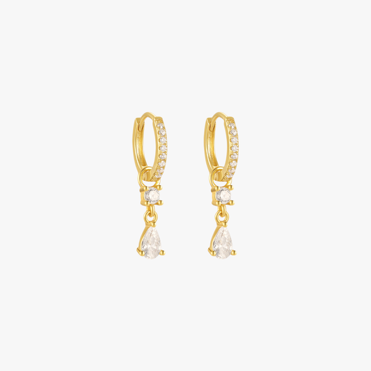 A pair of gold hoop earrings with teardrop charms, set with diamonds.