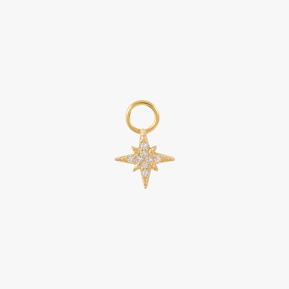 A gold north star charm with diamonds.