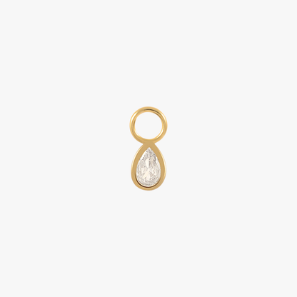 A gold teardrop charm with a diamond.