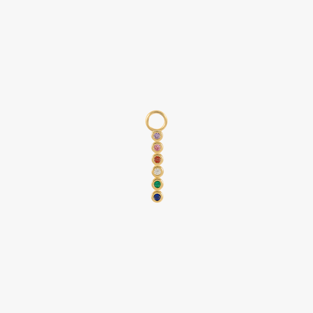 A gold charm with multi-colored gemstones.