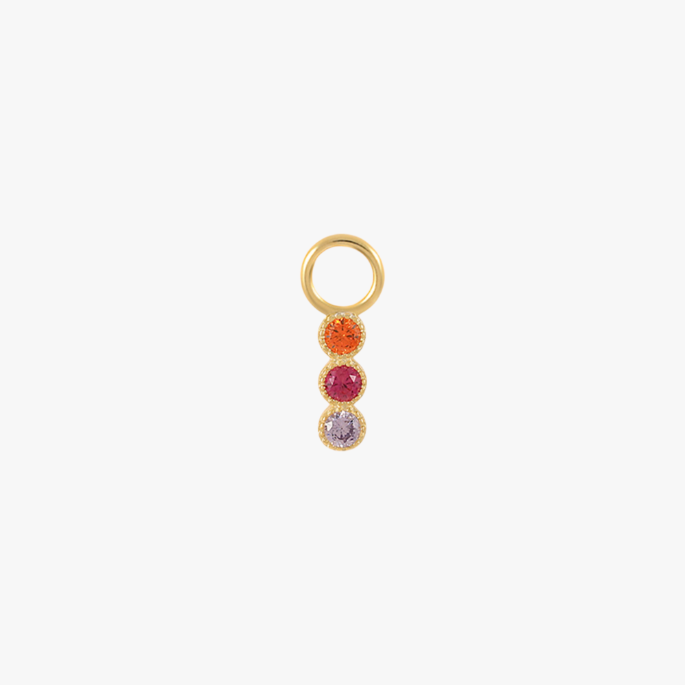 A gold charm with multi-colored gemstones.