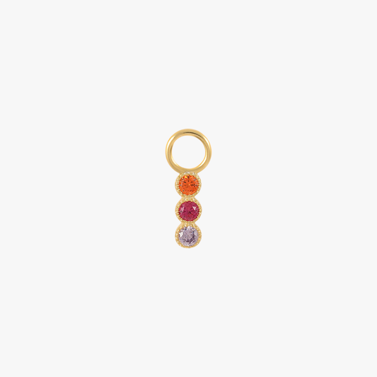 A gold charm with multi-colored gemstones.