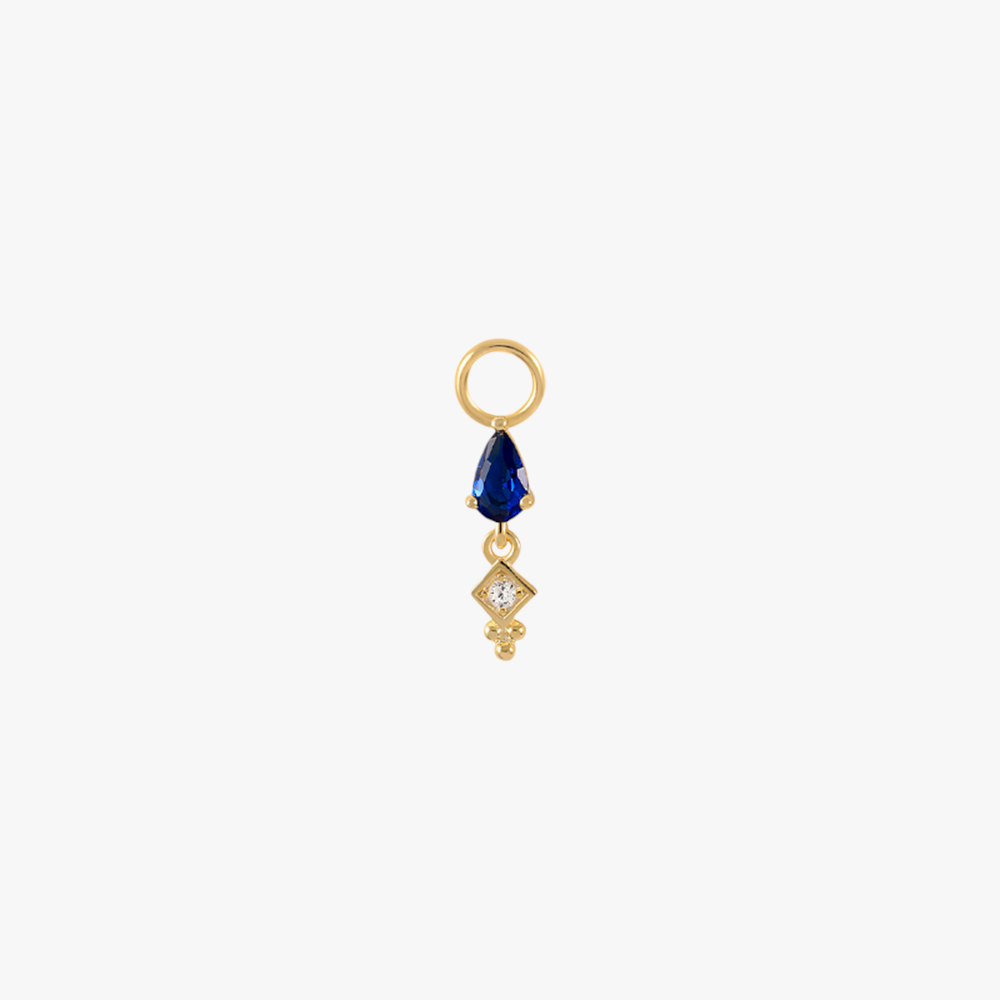 A gold charm with a sapphire and diamonds.