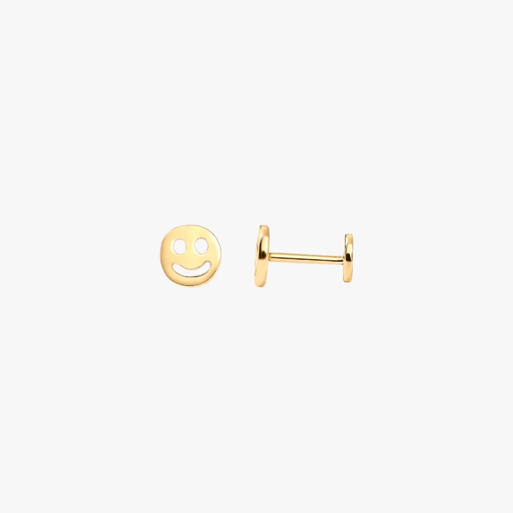 A pair of gold stud earrings with a smiley face design.