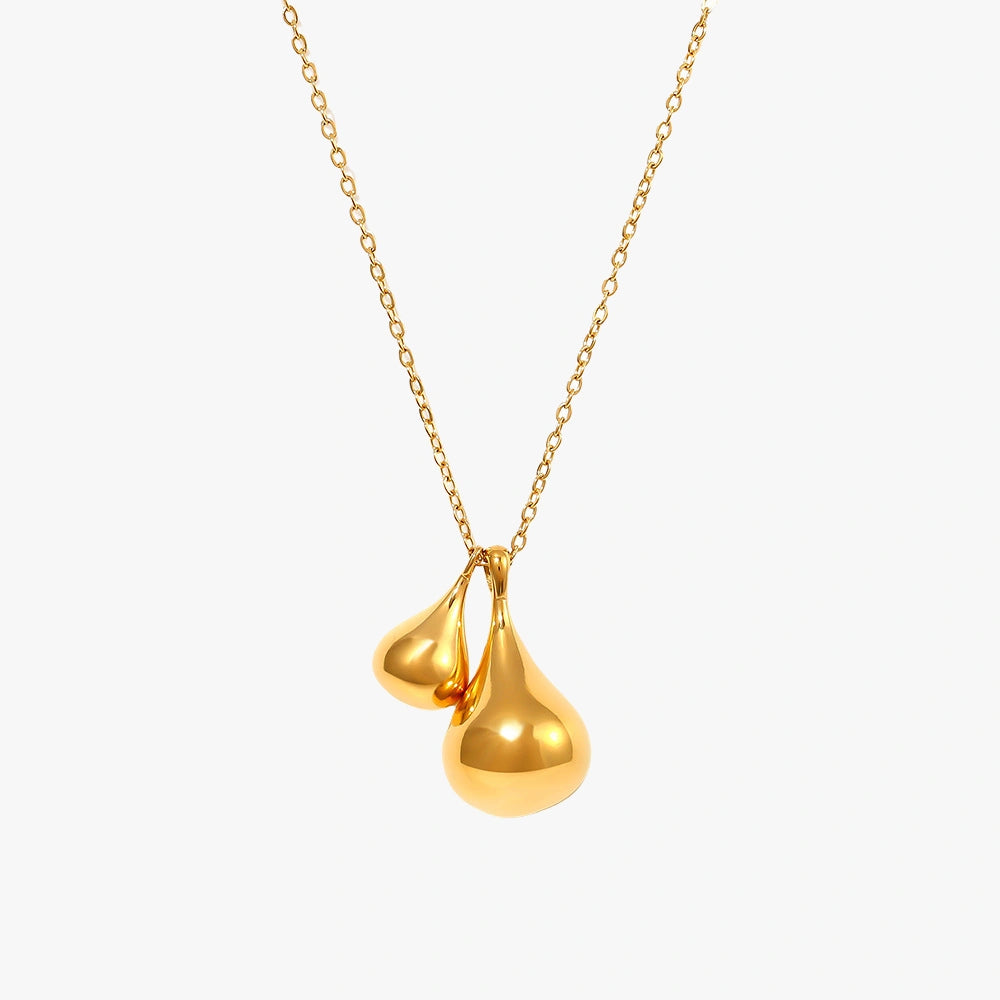 Elegant golden titanium plated water droplet pendant necklace on a white background.