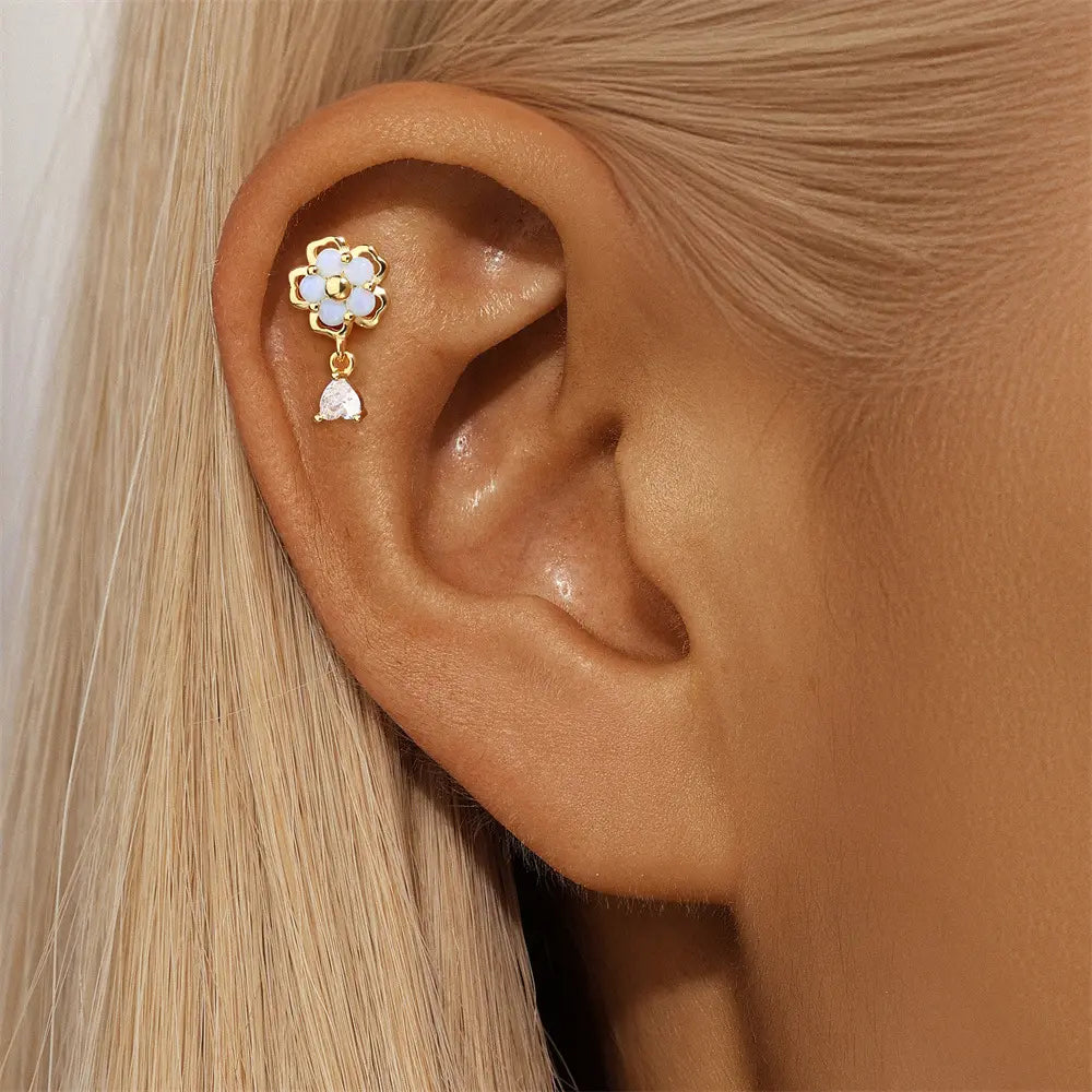 Model wearing 925 sterling silver opal flower earrings with crystal drop design.