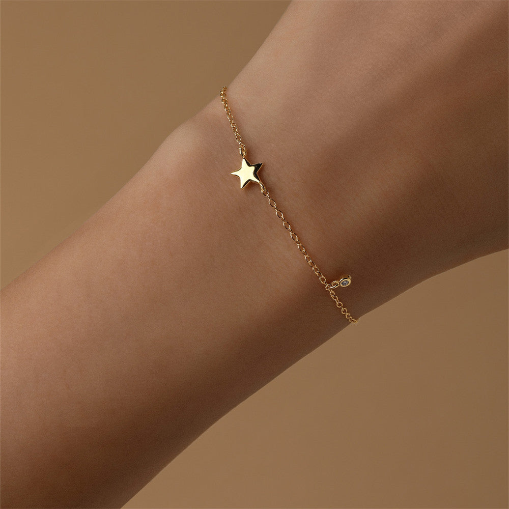 Close-up of a model's wrist wearing a 925 sterling silver bracelet with a five-pointed star design.