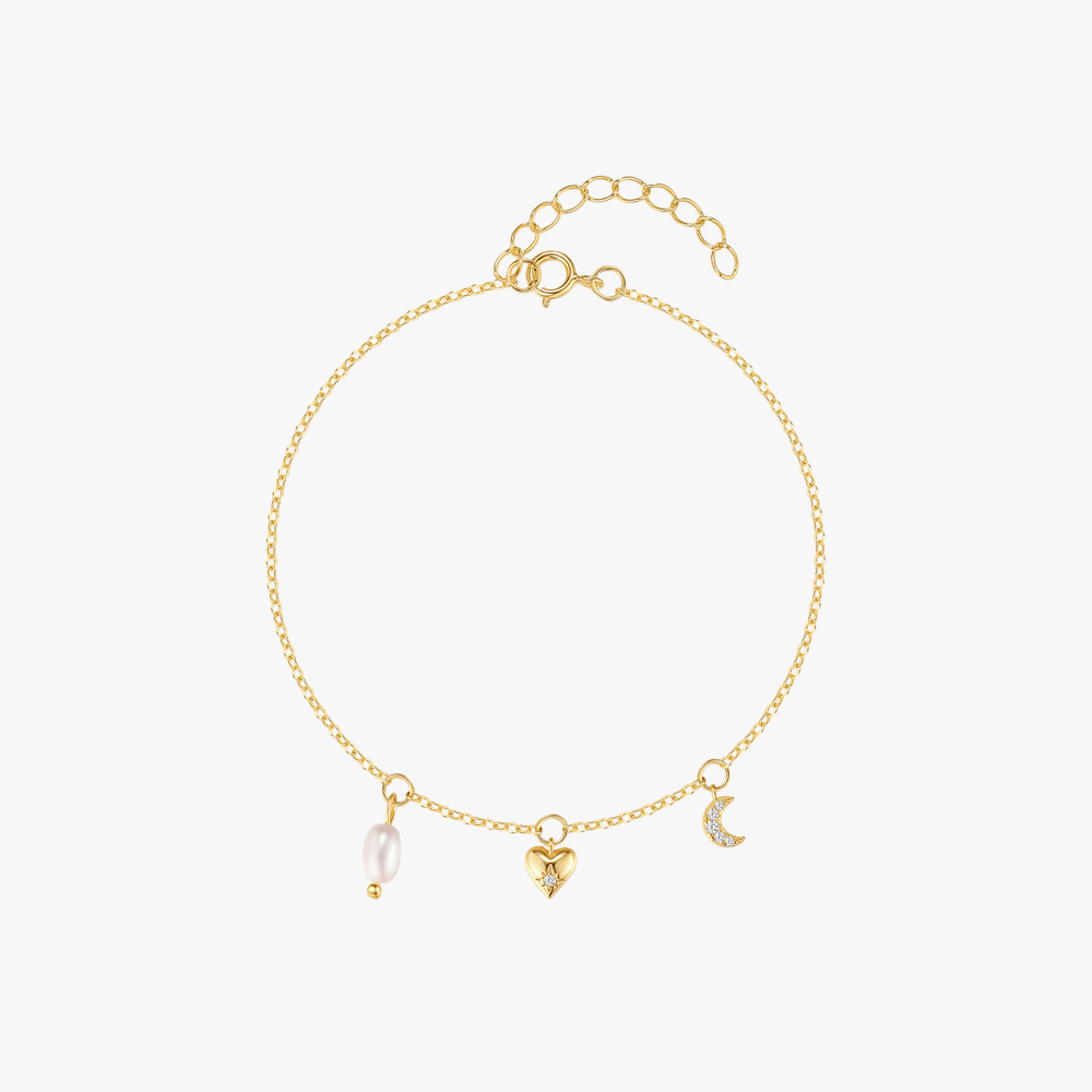 Delicate gold-plated charm bracelet featuring a pearl, heart, and crescent moon pendant, crafted from 925 sterling silver.