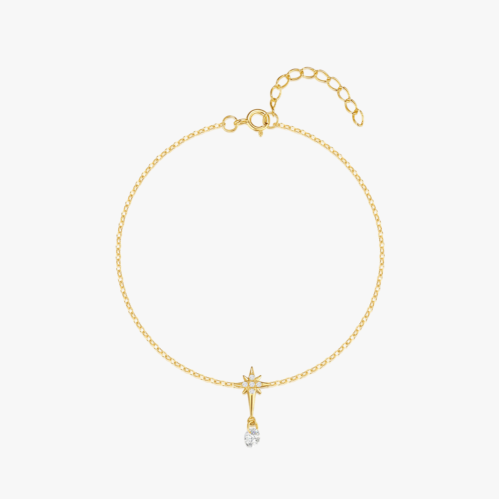 Gold star charm bracelet with zirconia drop detail and sterling silver base.