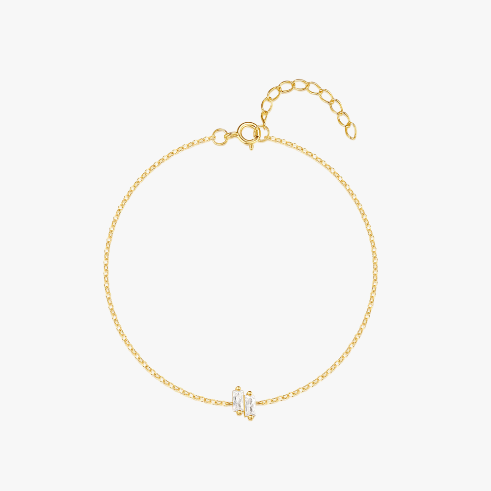 Elegant gold-plated bracelet featuring baguette-cut zirconia stones and a delicate chain design, crafted from 925 sterling silver.