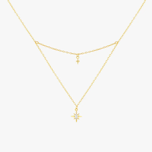 Gold layered necklace with a starburst pendant and a delicate small star charm, crafted in 925 sterling silver with gold plating.