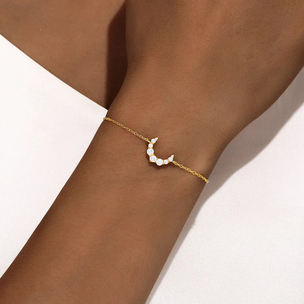 Model wearing 925 sterling silver opal moon bracelet with zirconia accents