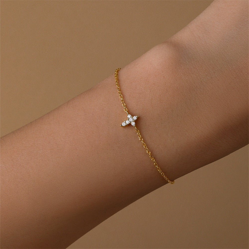 S925 Sterling Silver bracelet with zirconia cross worn on wrist, showcasing its elegance.