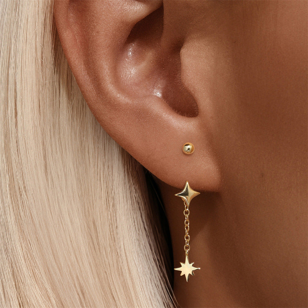 Model wearing elegant gold star earrings made of real 18k gold. Stylish and perfect for adding a touch of sophistication to any look.