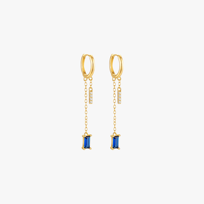 Gold drop earrings with blue gemstones, luxurious and trendy.