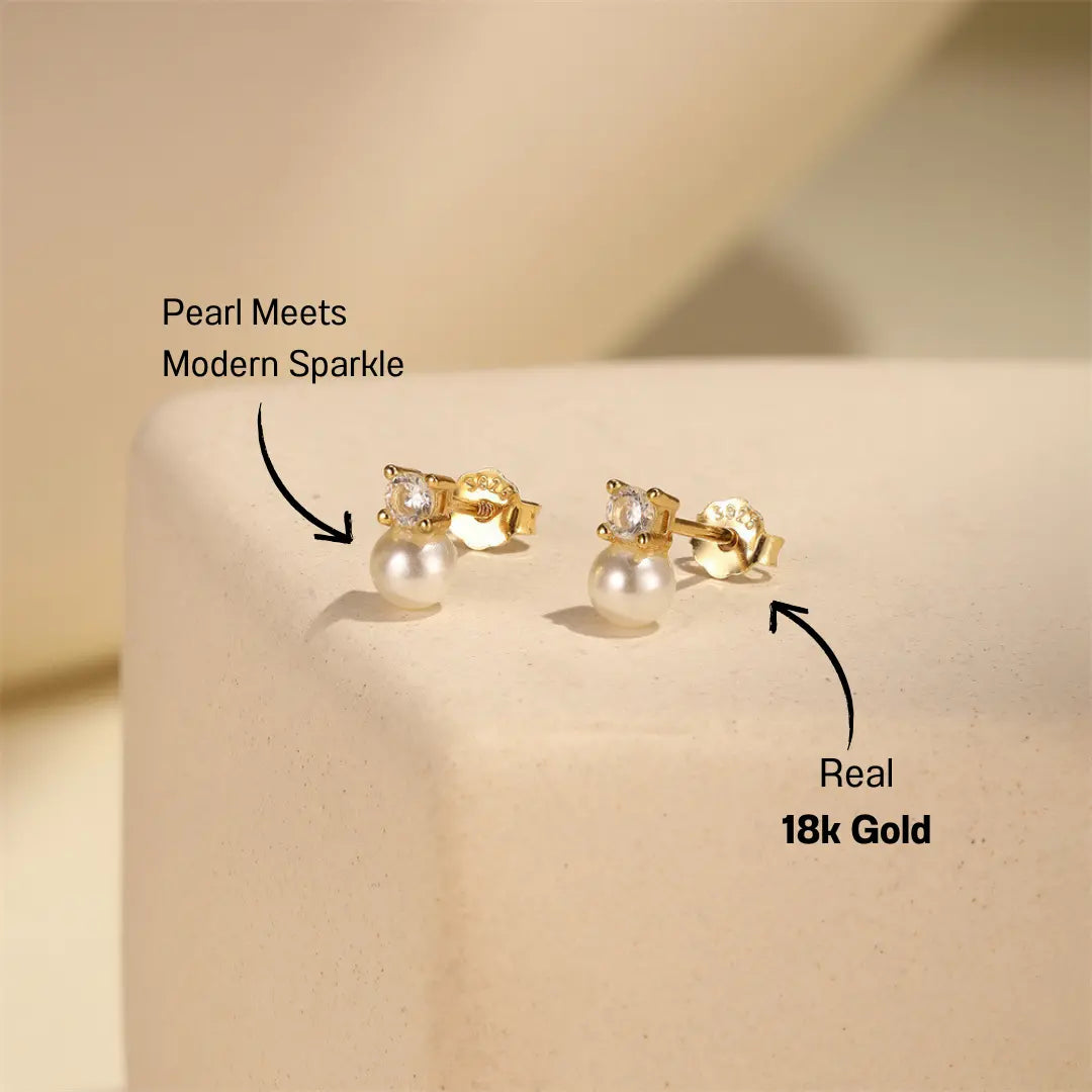 Classic Pearl Stud Earrings with sparkling cubic zirconia and lustrous pearls, styled on a neutral background, made with 925 sterling silver and 18K gold plating.